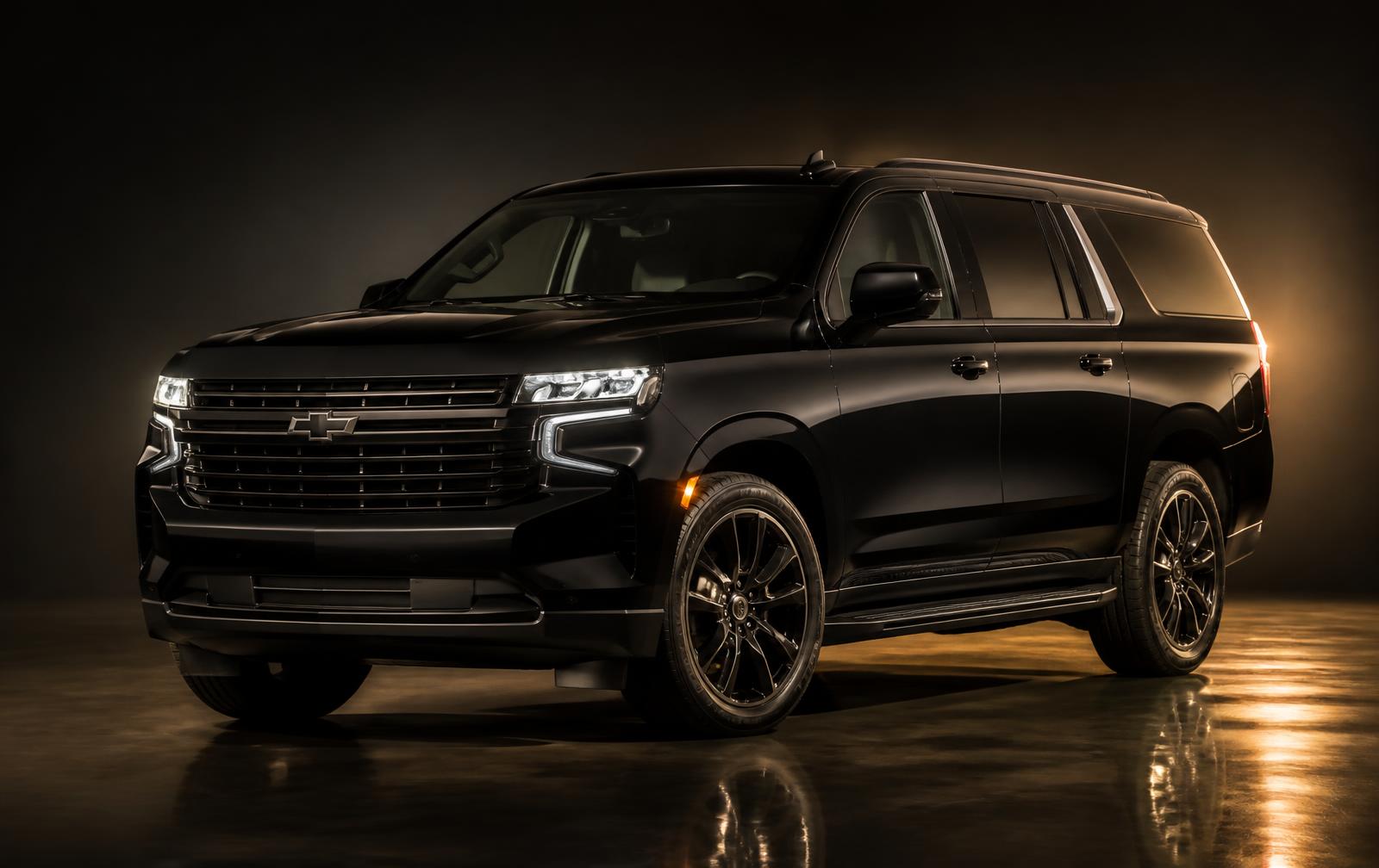 Black executive SUV photographed against a dark studio backdrop